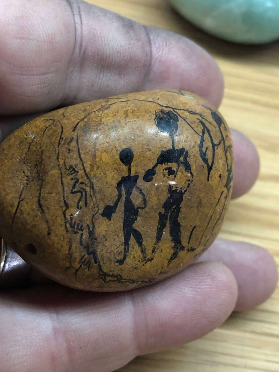 Collection of precious stone eggs and a bushmen painted rock