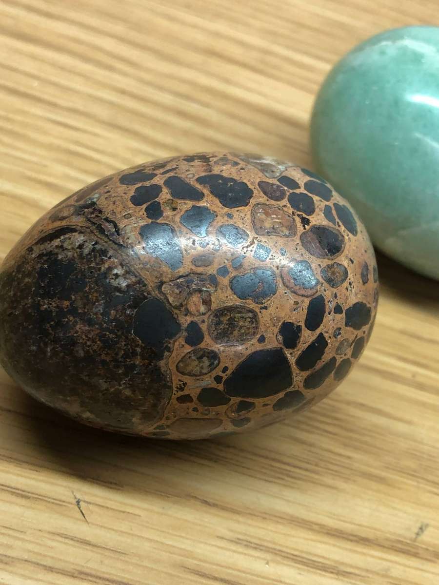 Collection of precious stone eggs and a bushmen painted rock