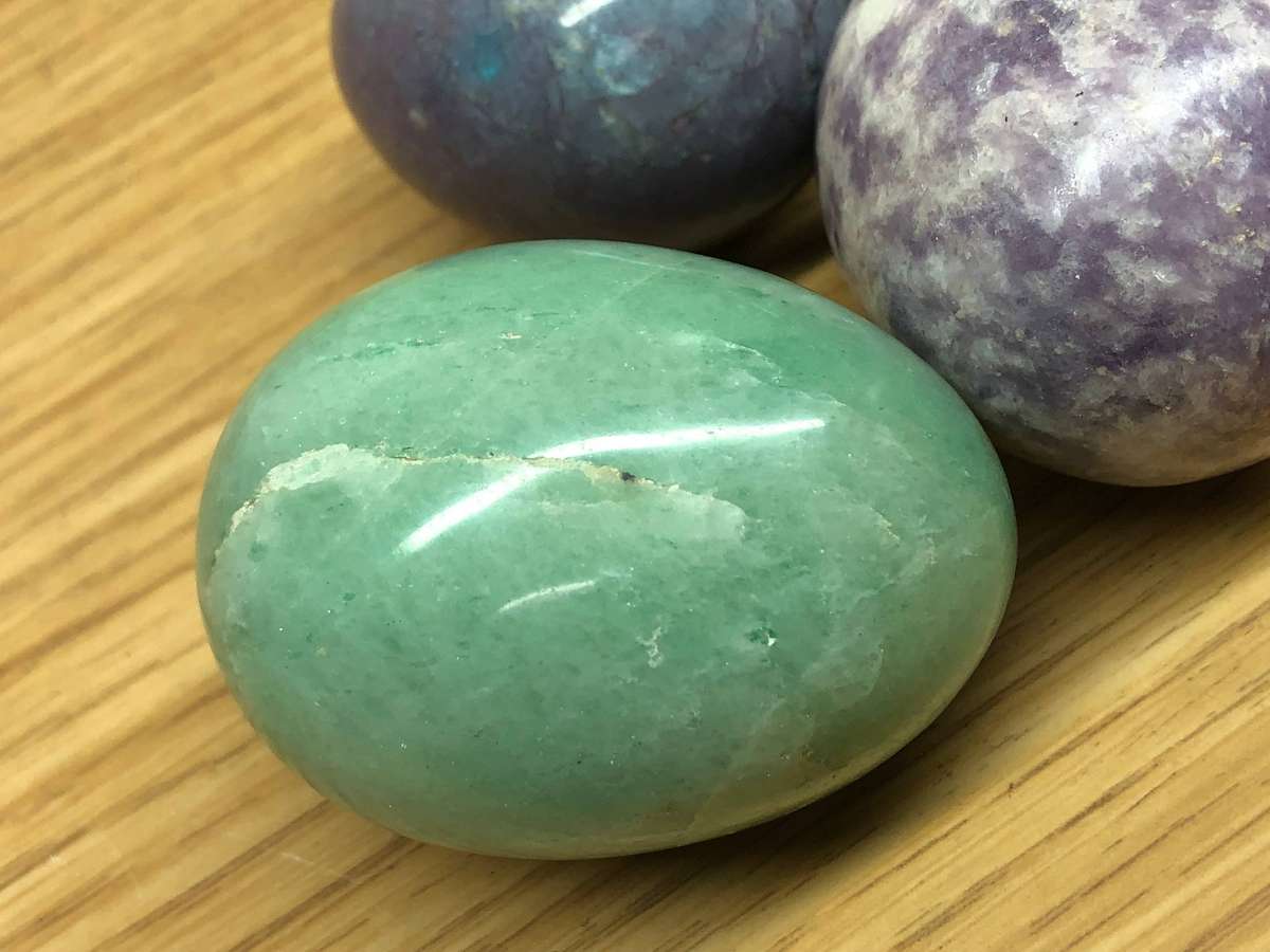 Collection of precious stone eggs and a bushmen painted rock