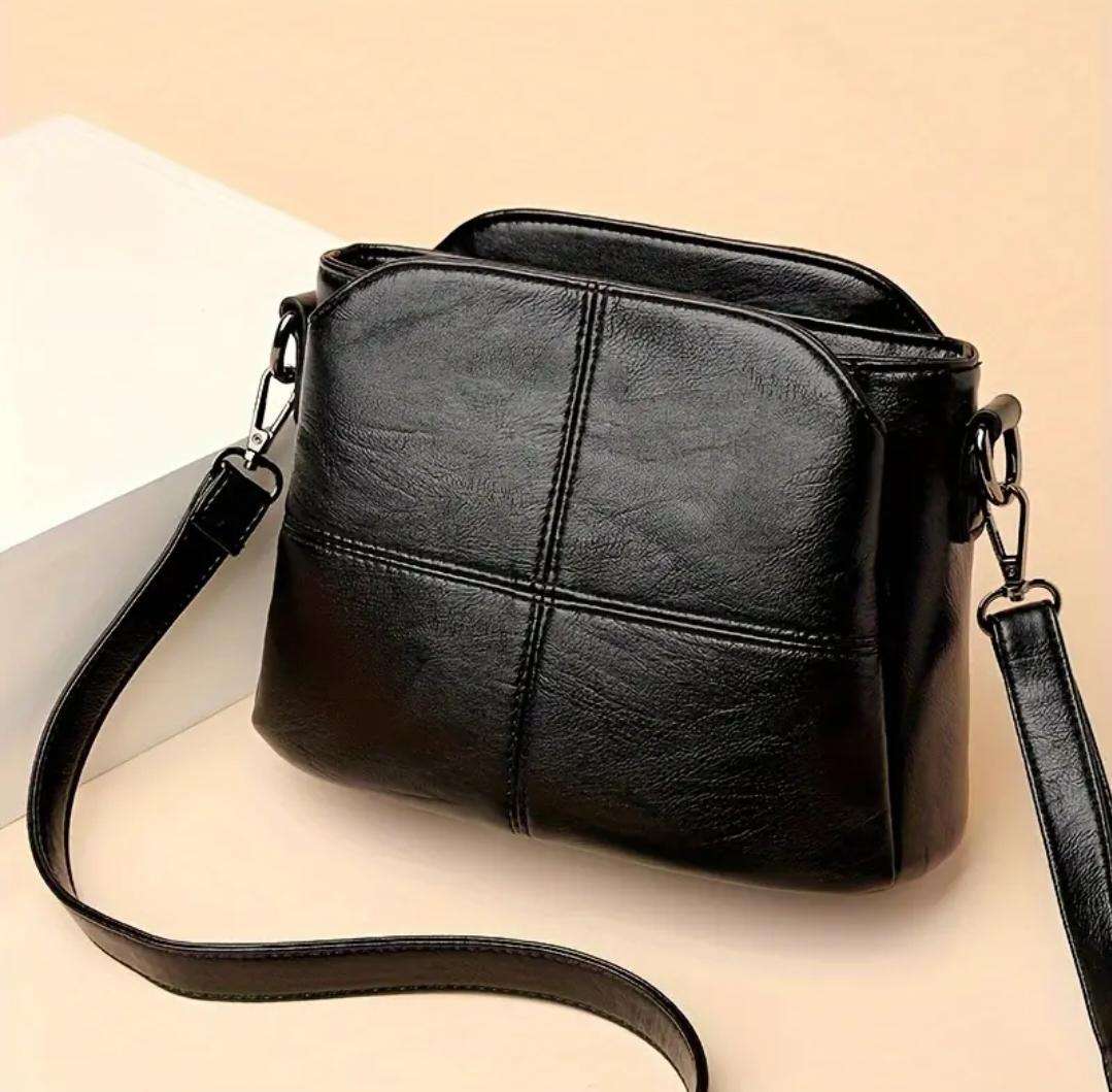 Womans shoulder sling handbag