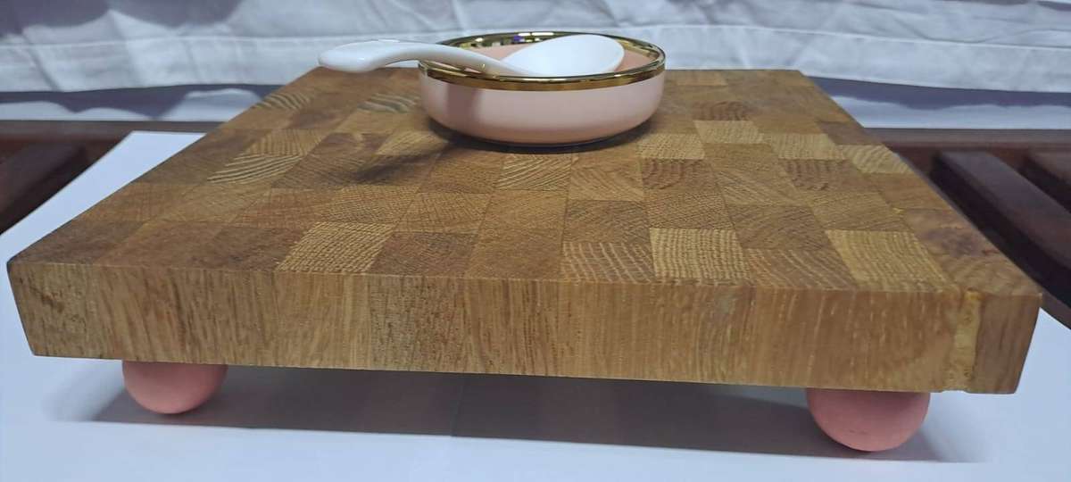 Cutting/Serving board and small pink and gold-rimmed ceramic bowl and spoon