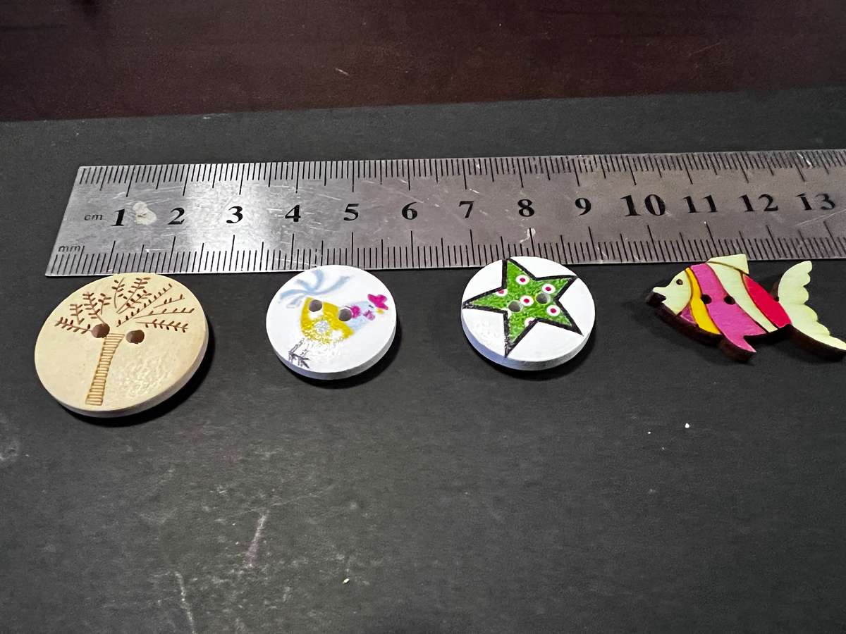 Mixed  assorted buttons with pictures including chickens, stars, tree and fish