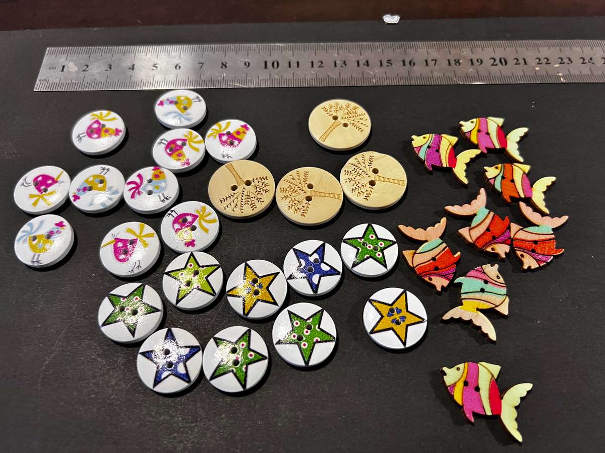 Mixed  assorted buttons with pictures including chickens, stars, tree and fish