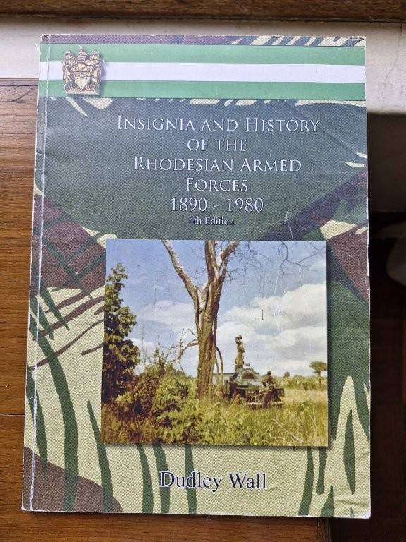 Book, Insignia and History of the Rhodesian Armed Force by Dudley Wall. Spine broken and pages loose