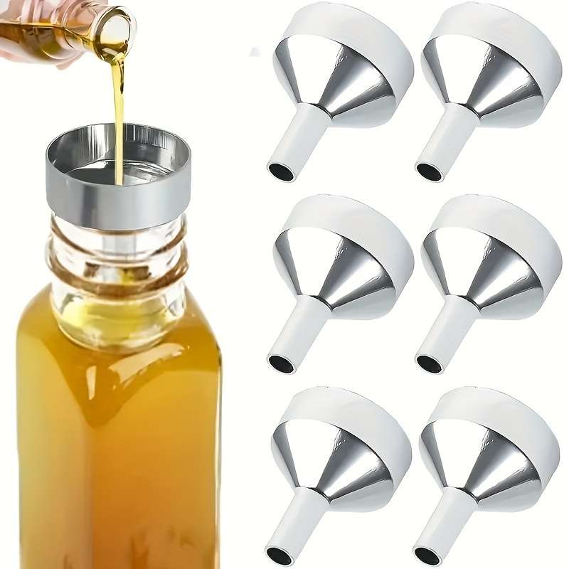 A Set Of Small Golden Funnels Specially Designed For Perfumes And Essential Oils