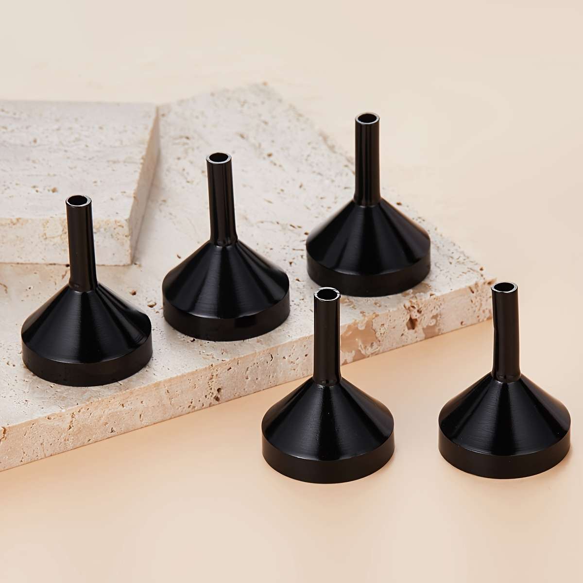 A Set Of Small Golden Funnels Specially Designed For Perfumes And Essential Oils