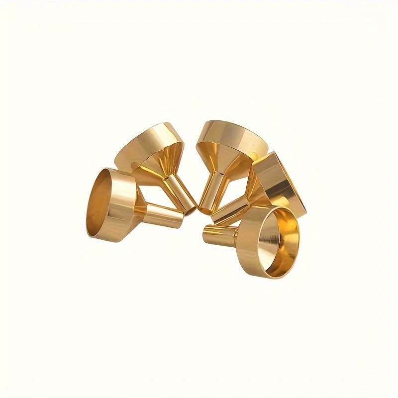 A Set Of Small Golden Funnels Specially Designed For Perfumes And Essential Oils