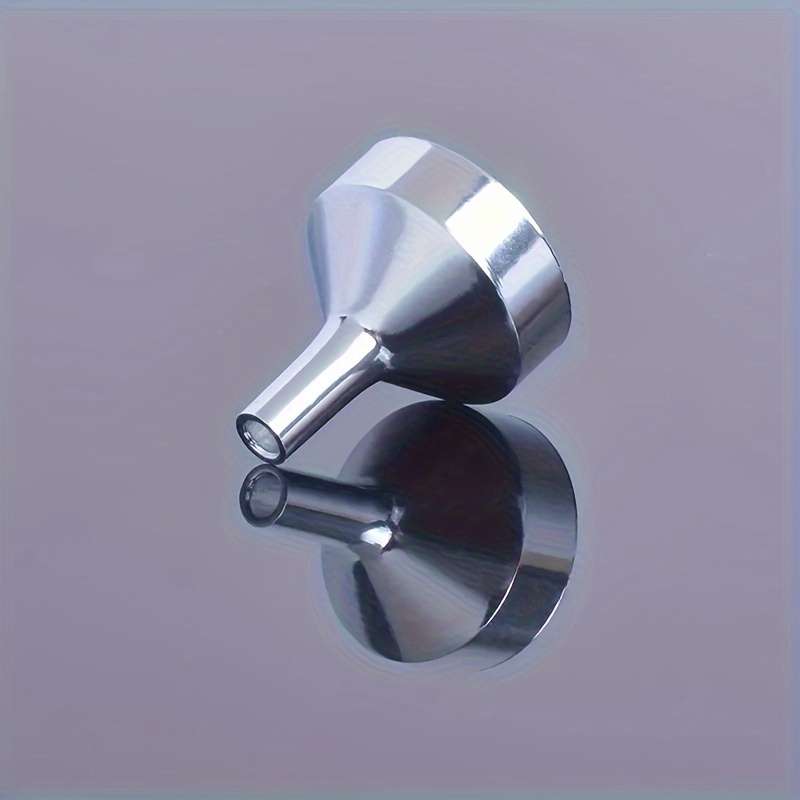 A Set Of Small Golden Funnels Specially Designed For Perfumes And Essential Oils