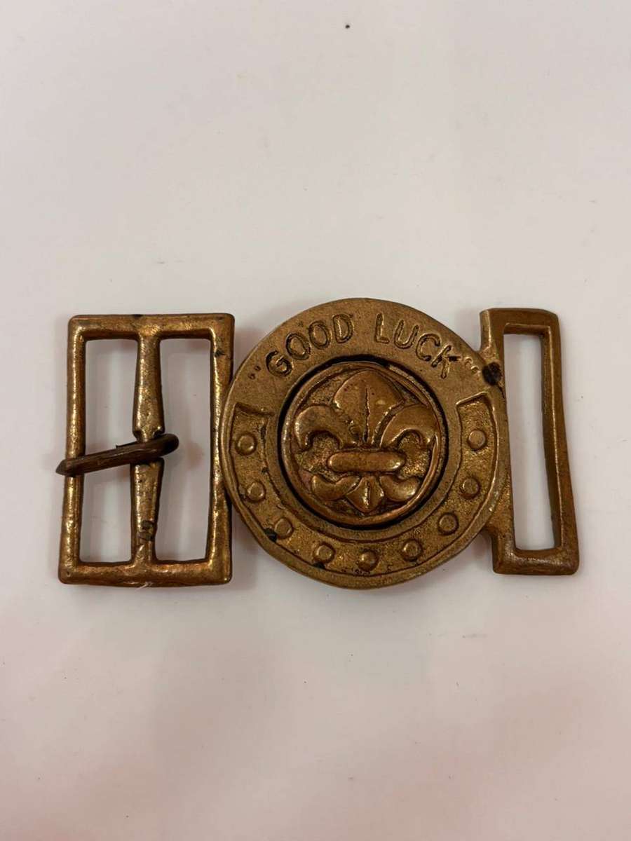 Vintage brass belt buckle featuring a Boy Scouts fleur-de-lis emblem and the phrase "GOOD LUCK