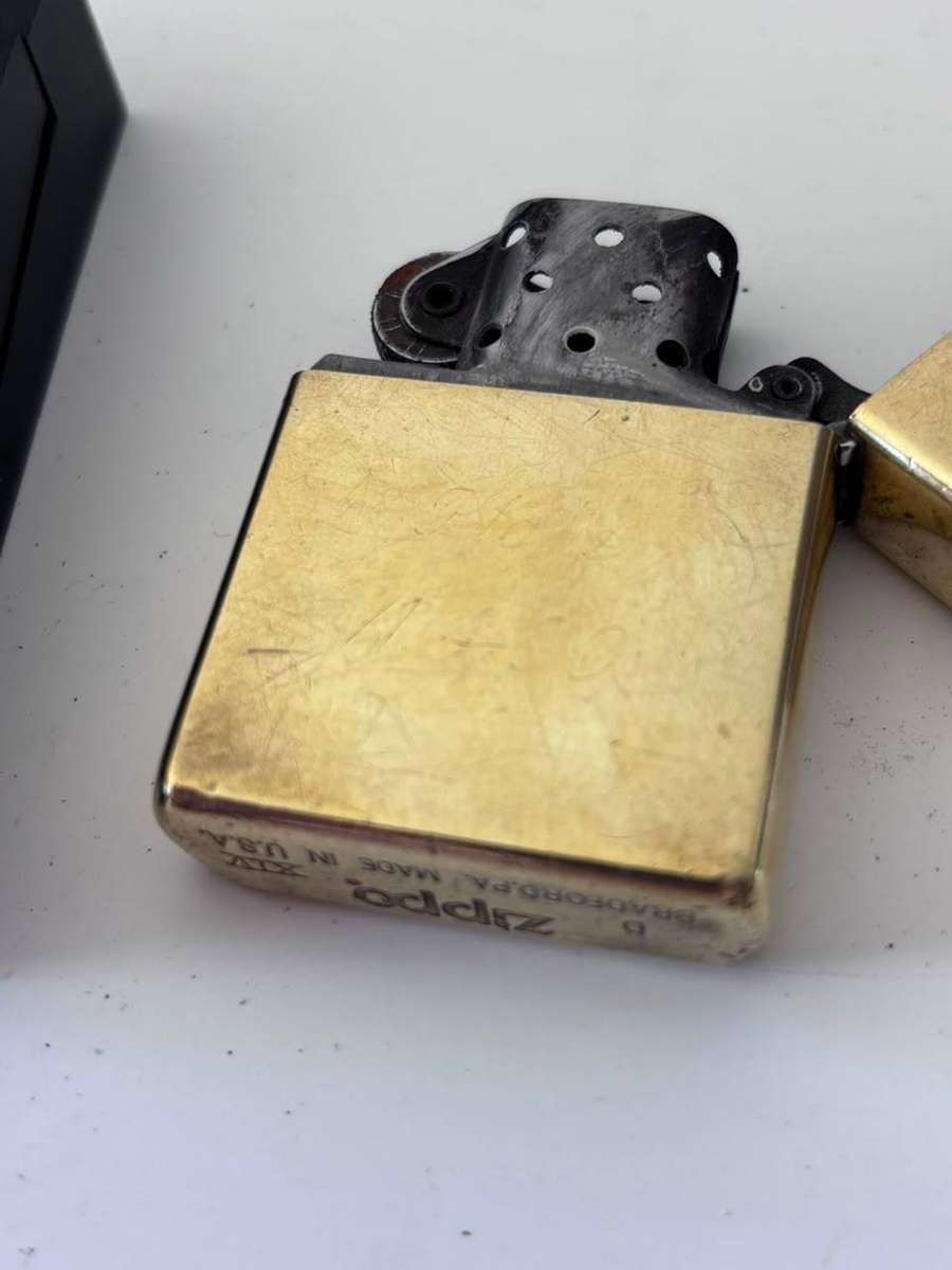 Classic Brass Windproof Zippo Lighter with its Original Black Plastic Packaging Box