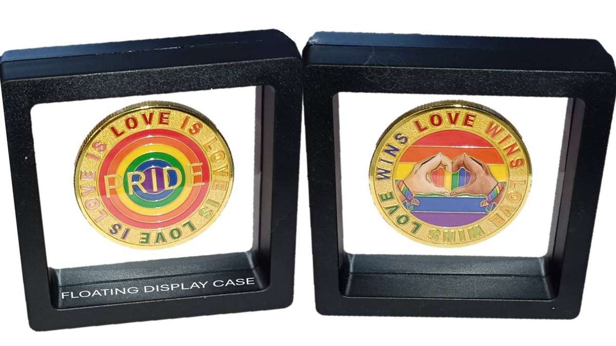 Human Rights day - 21 Mar: Encapsulated Love and Pride Medallion in transparent display case.