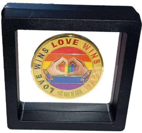 Human Rights day - 21 Mar: Encapsulated Love and Pride Medallion in transparent display case.