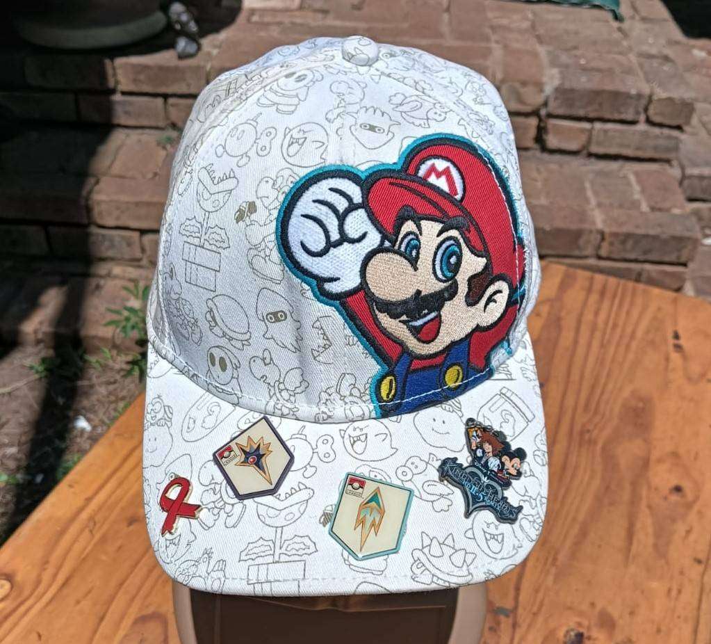 Super Mario Brothers Nintendo 2012 Snapback Cap with 2 pinned Pokemon League Gym Badges
