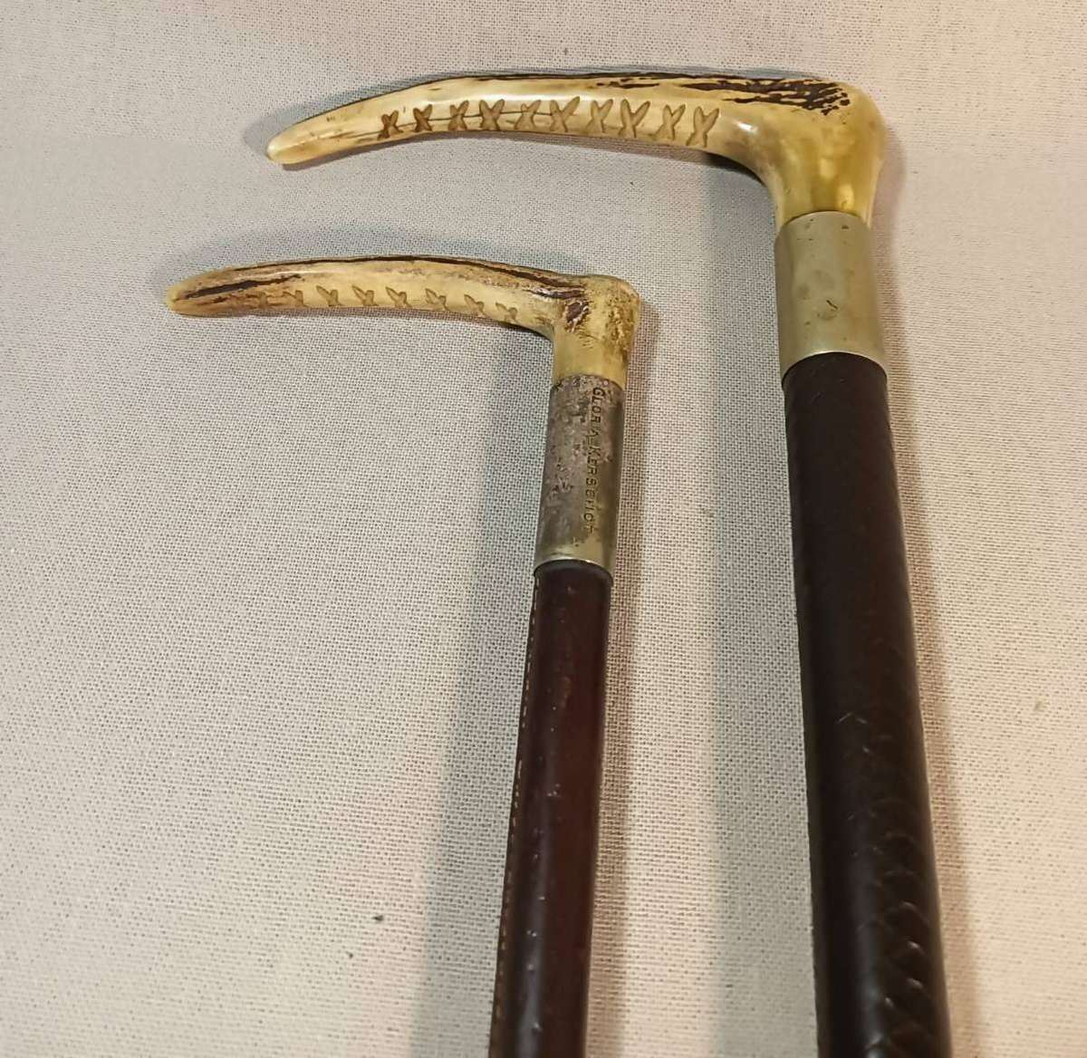 Two Antique Leather and Bone Handle Hunting Crops one with a Gloria Kerschot Silver Metal Collar