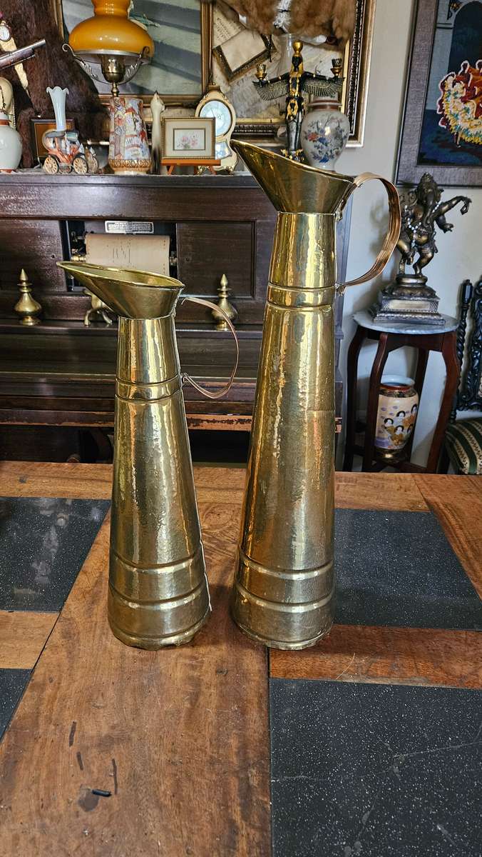 Two Tall Brass Pitchers