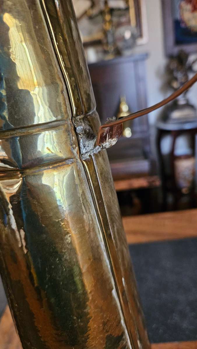 Two Tall Brass Pitchers