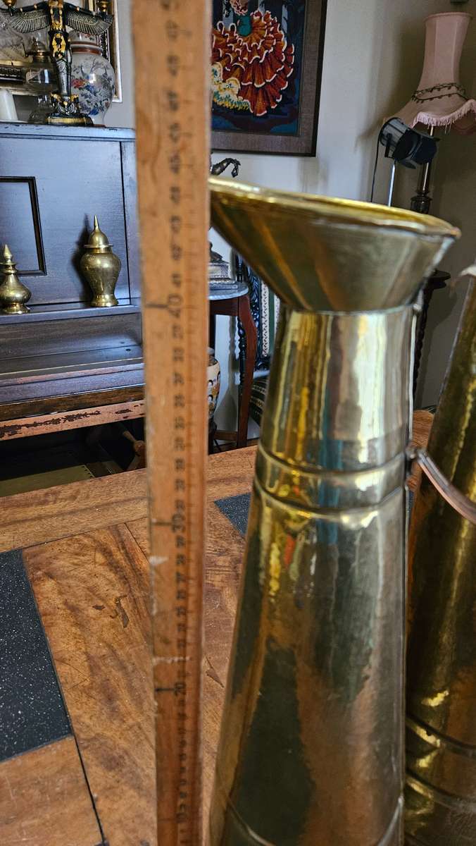 Two Tall Brass Pitchers