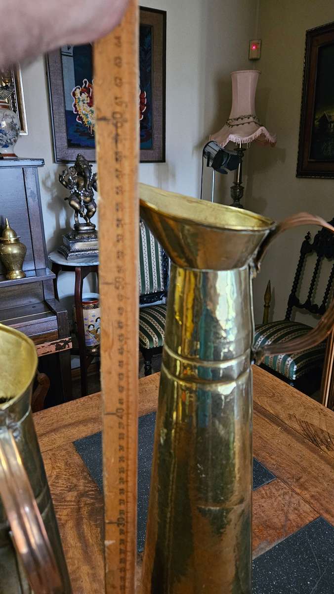Two Tall Brass Pitchers