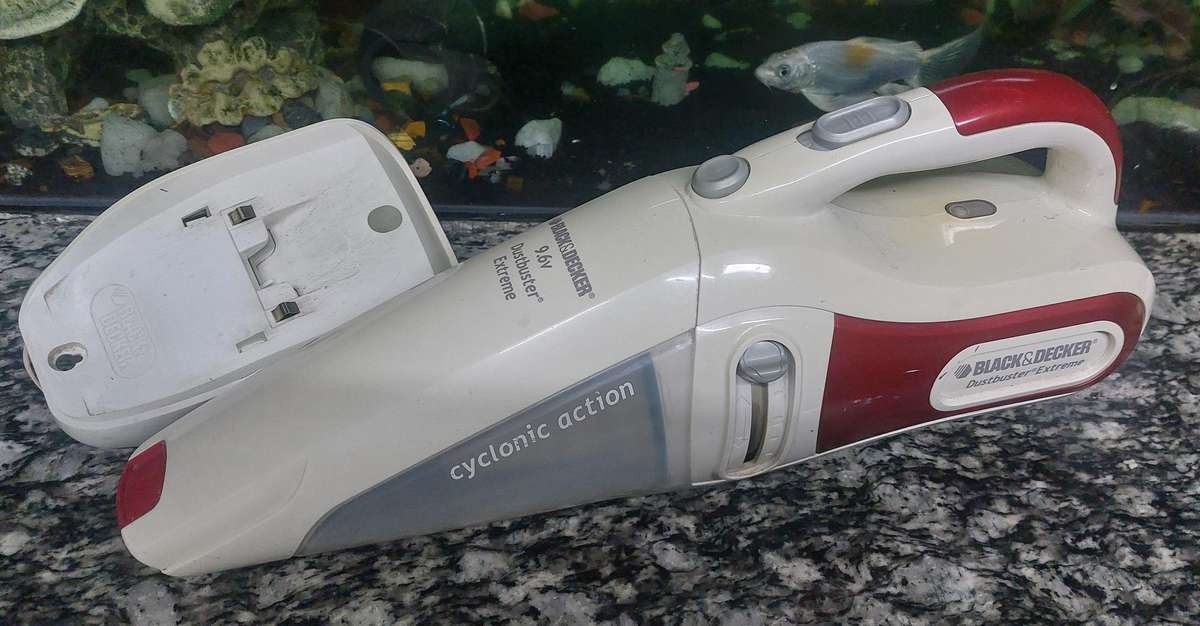 rechargeable black and decker dust buster with charger and docking unit.