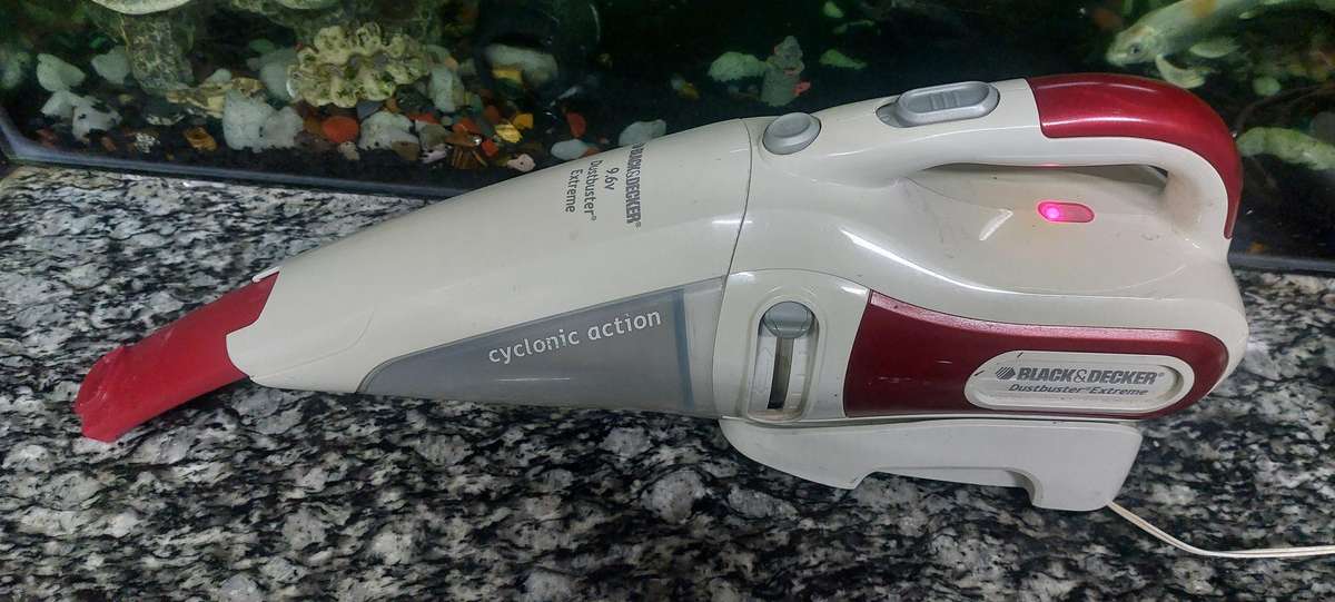 rechargeable black and decker dust buster with charger and docking unit.