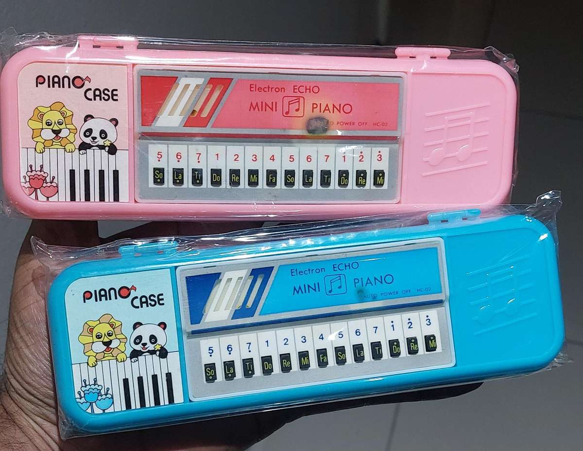 Vintage piano pencil cases very old still sealed comes with song book.