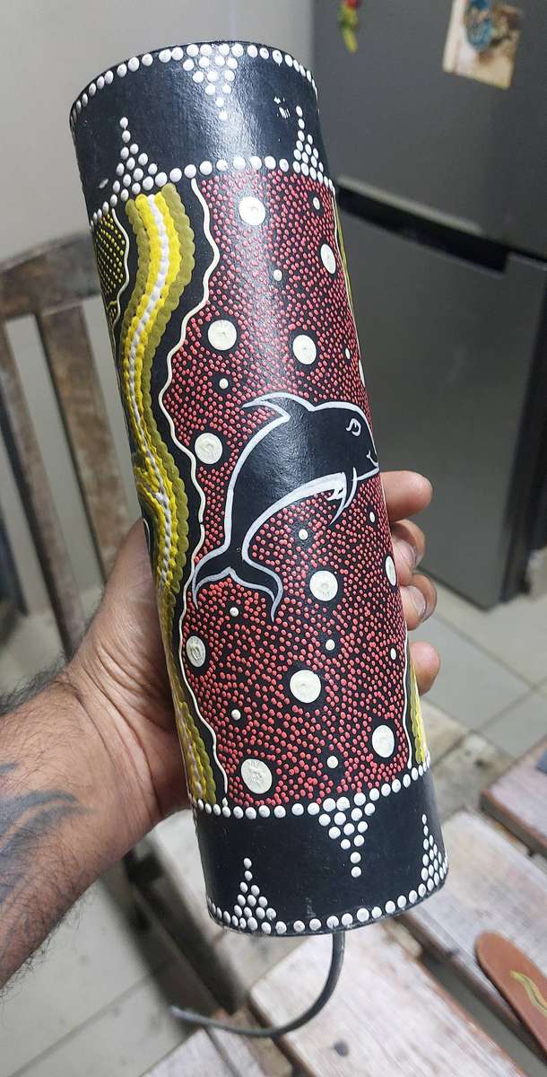 Authentic boomerang and aborianese thunder drum mimics the sound of thunder storm