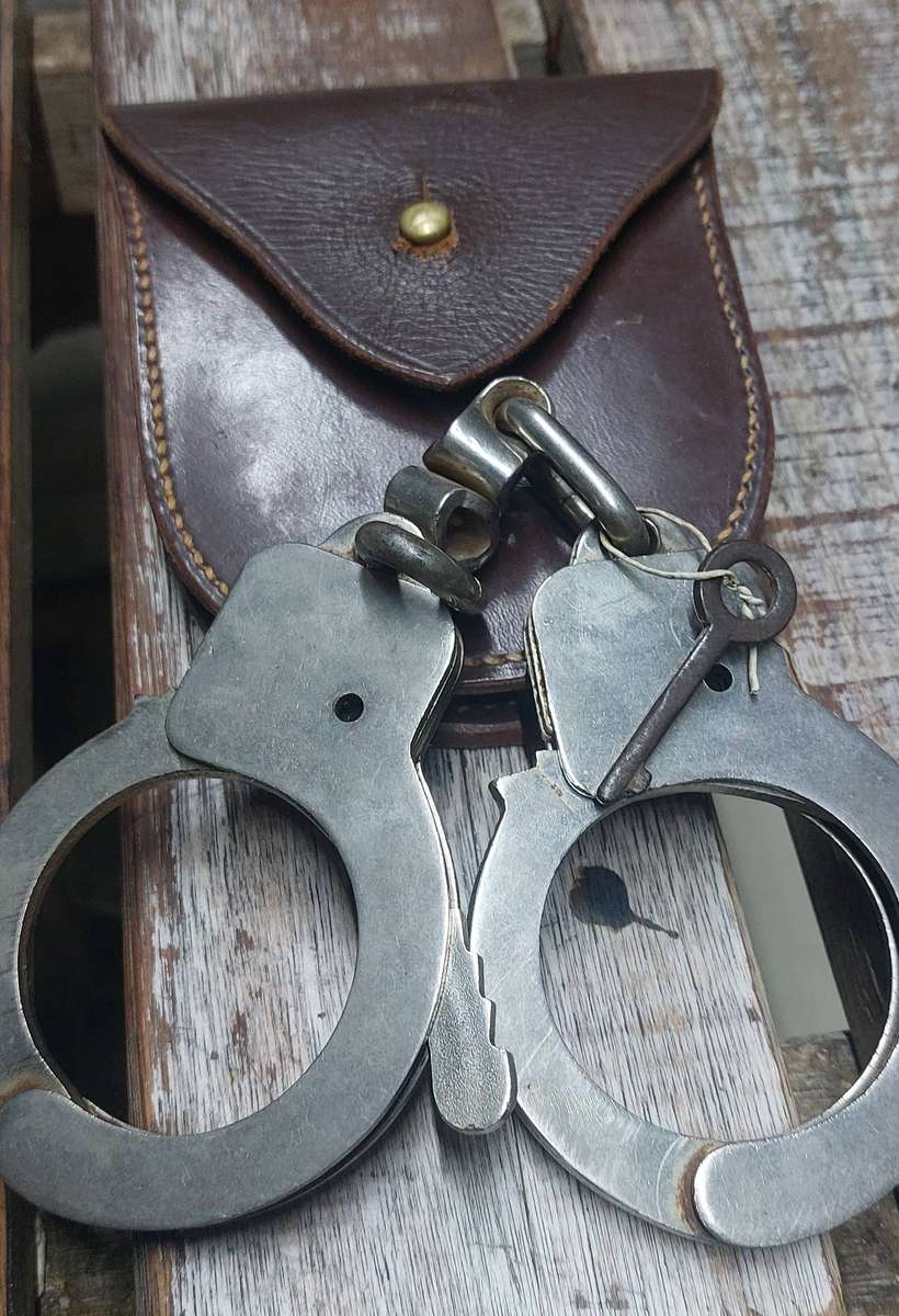Vintage police  hand cuffs with key and leather pouch