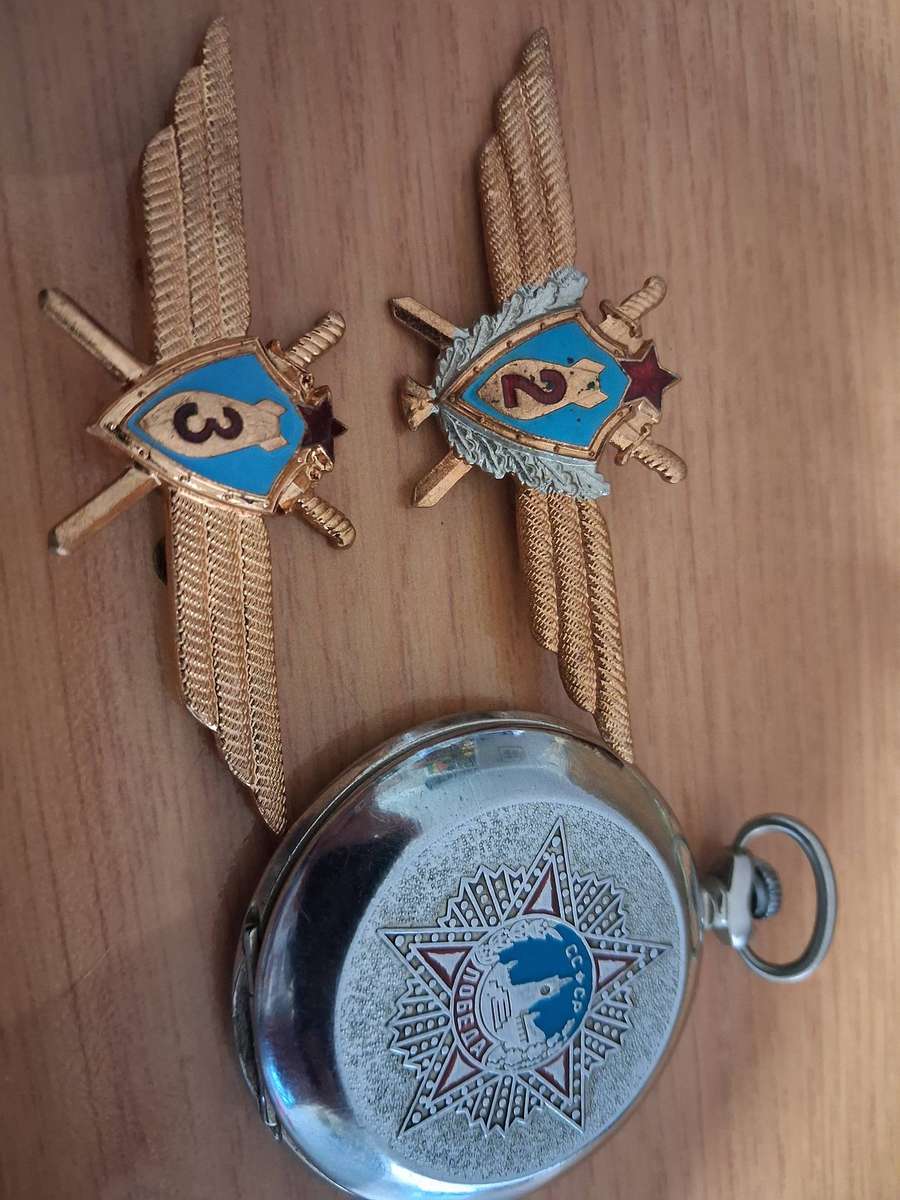 Vintage world war 2 pocket watch and  badges winds