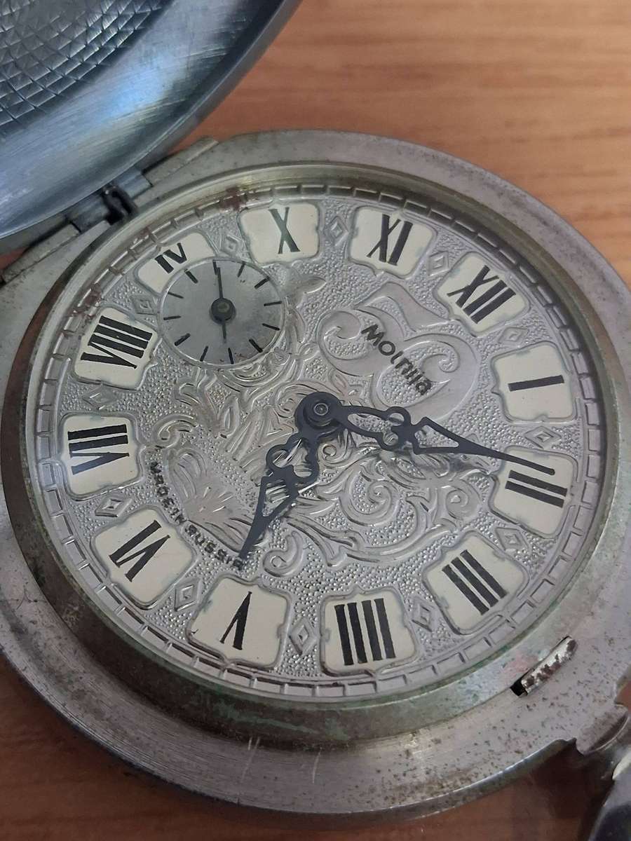 Vintage world war 2 pocket watch and  badges winds