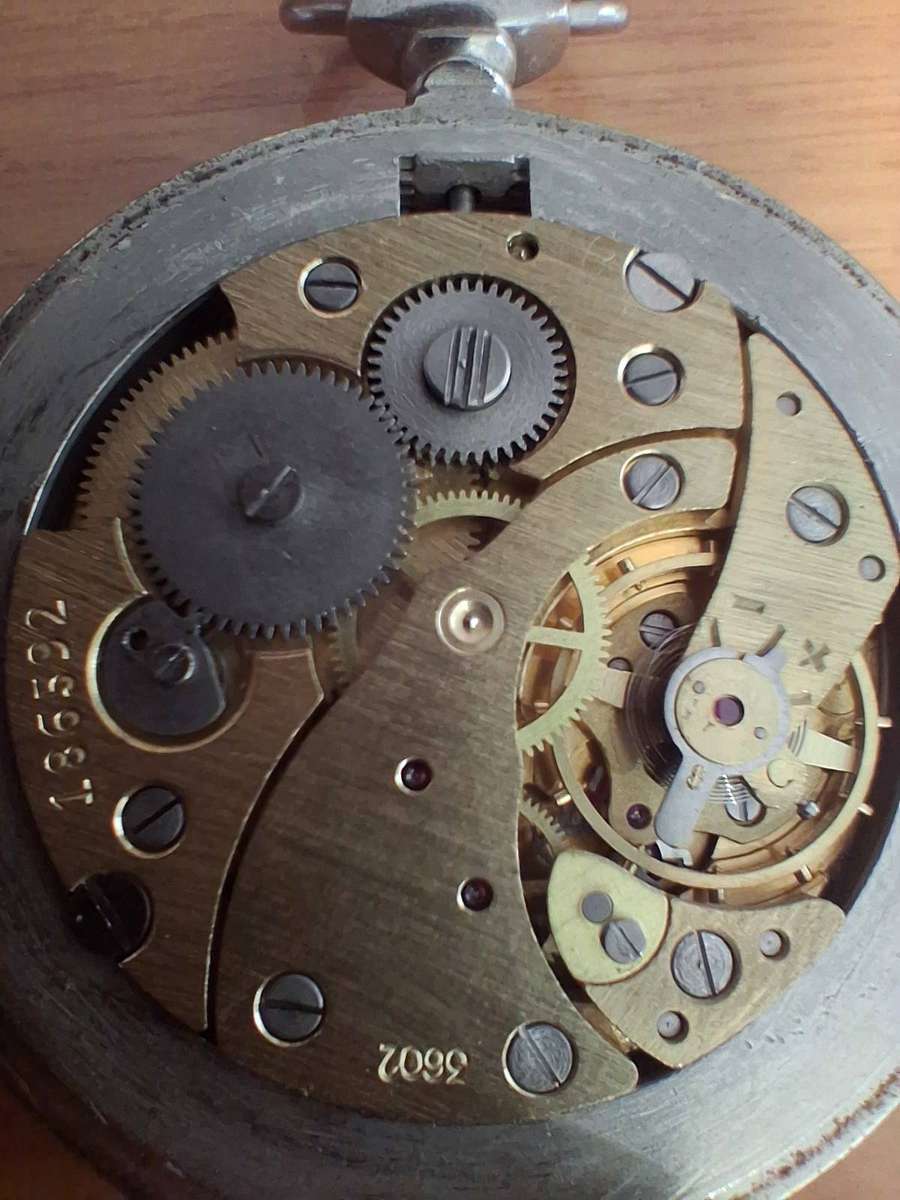 Vintage world war 2 pocket watch and  badges winds