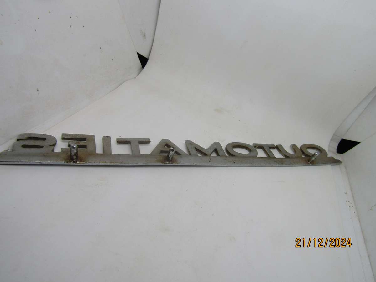 Vintage Ford Fairlane Outomaties Metal Sign. Pins intact. 27CM