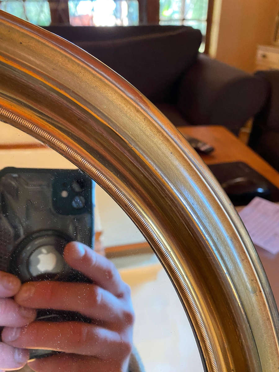 EDWARDIAN OVAL BRASS-FRAMED WALL MIRROR