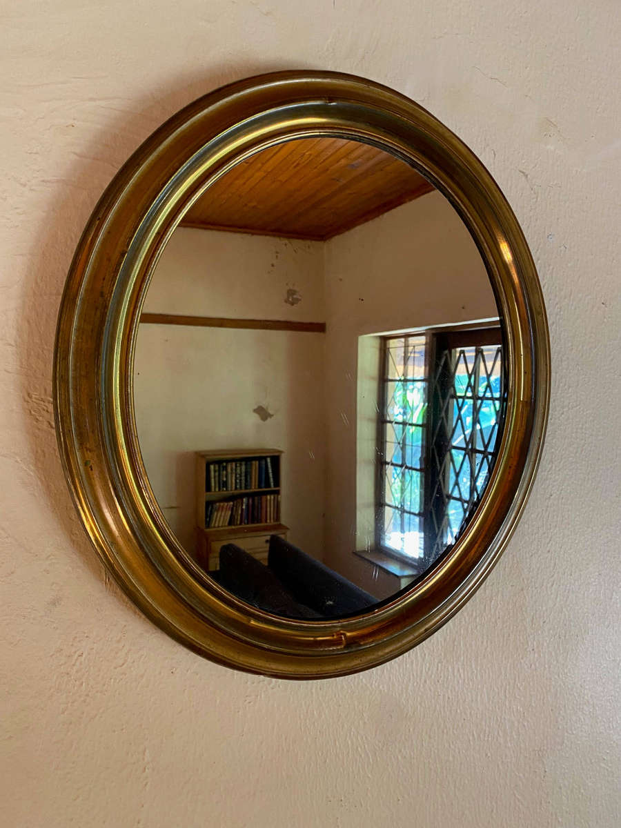 EDWARDIAN OVAL BRASS-FRAMED WALL MIRROR