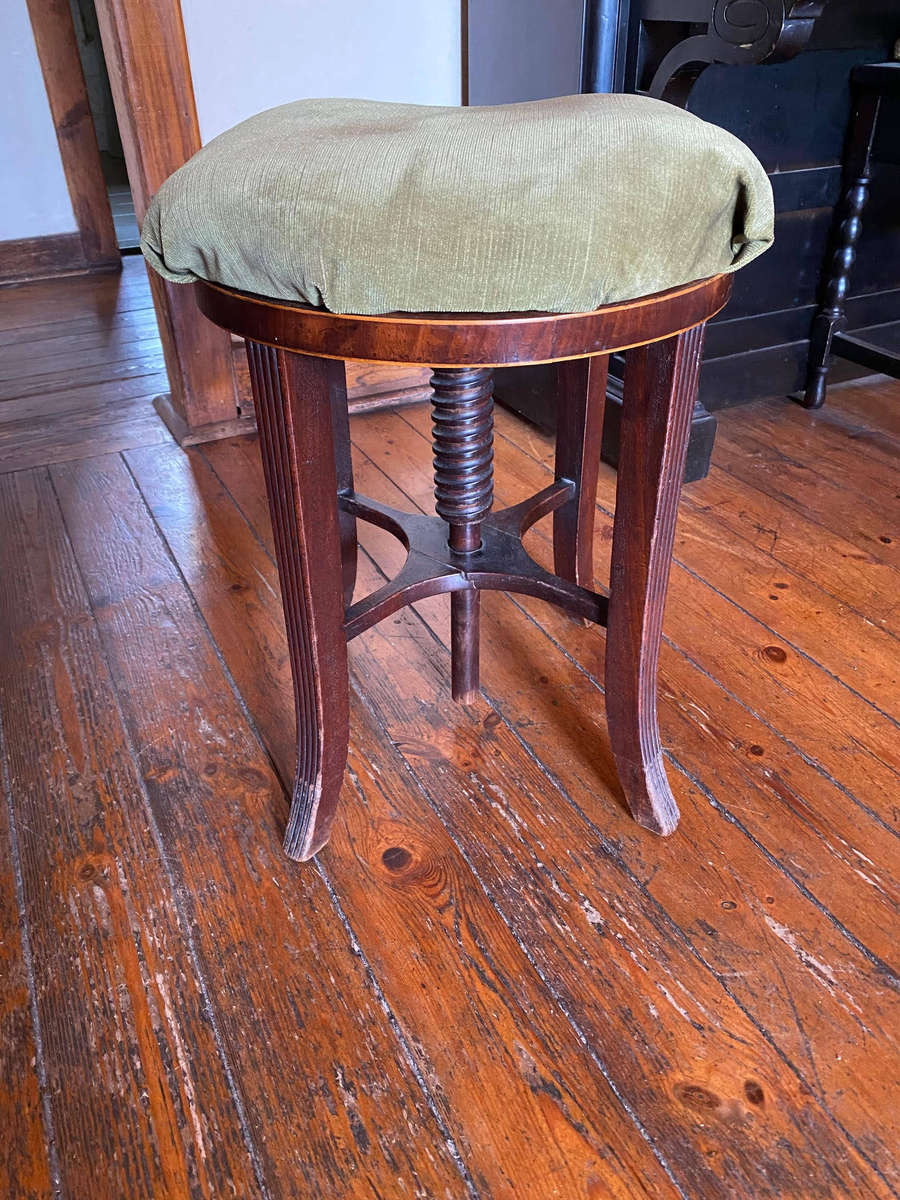 A Victorian mahogany adjustable circular piano stool
