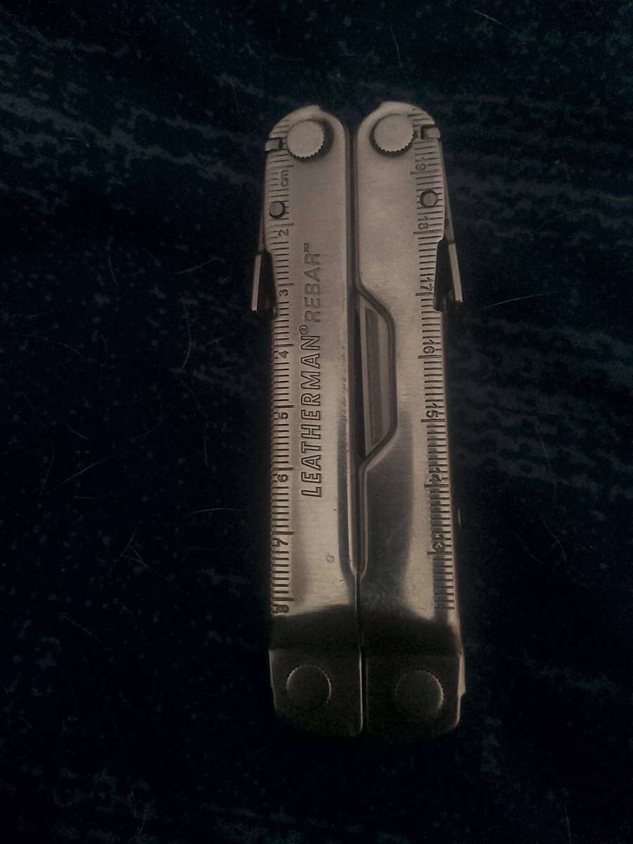 LEATHERMAN REBAR AND GENUINE LEATHER POUCH IN GOOD WORKING CONDITION.