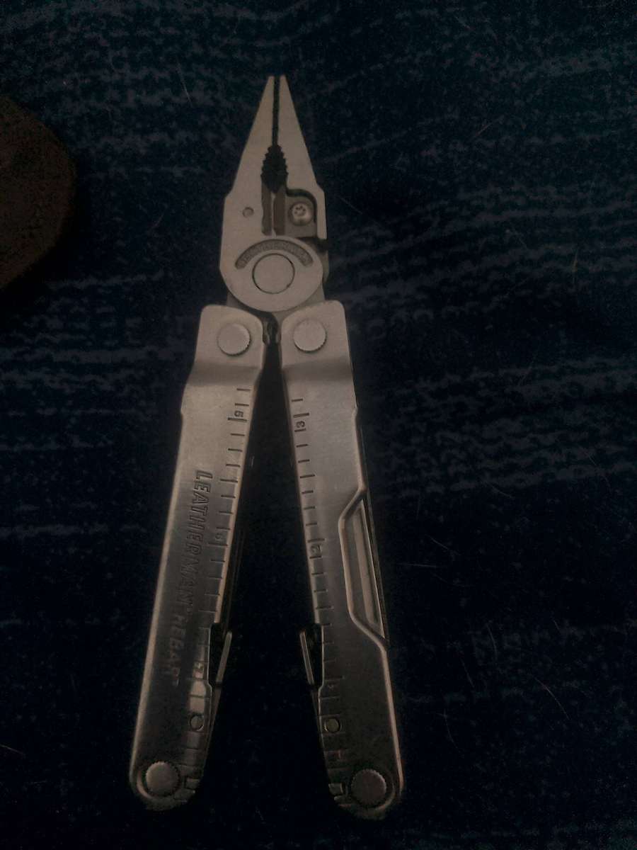 LEATHERMAN REBAR AND GENUINE LEATHER POUCH IN GOOD WORKING CONDITION.