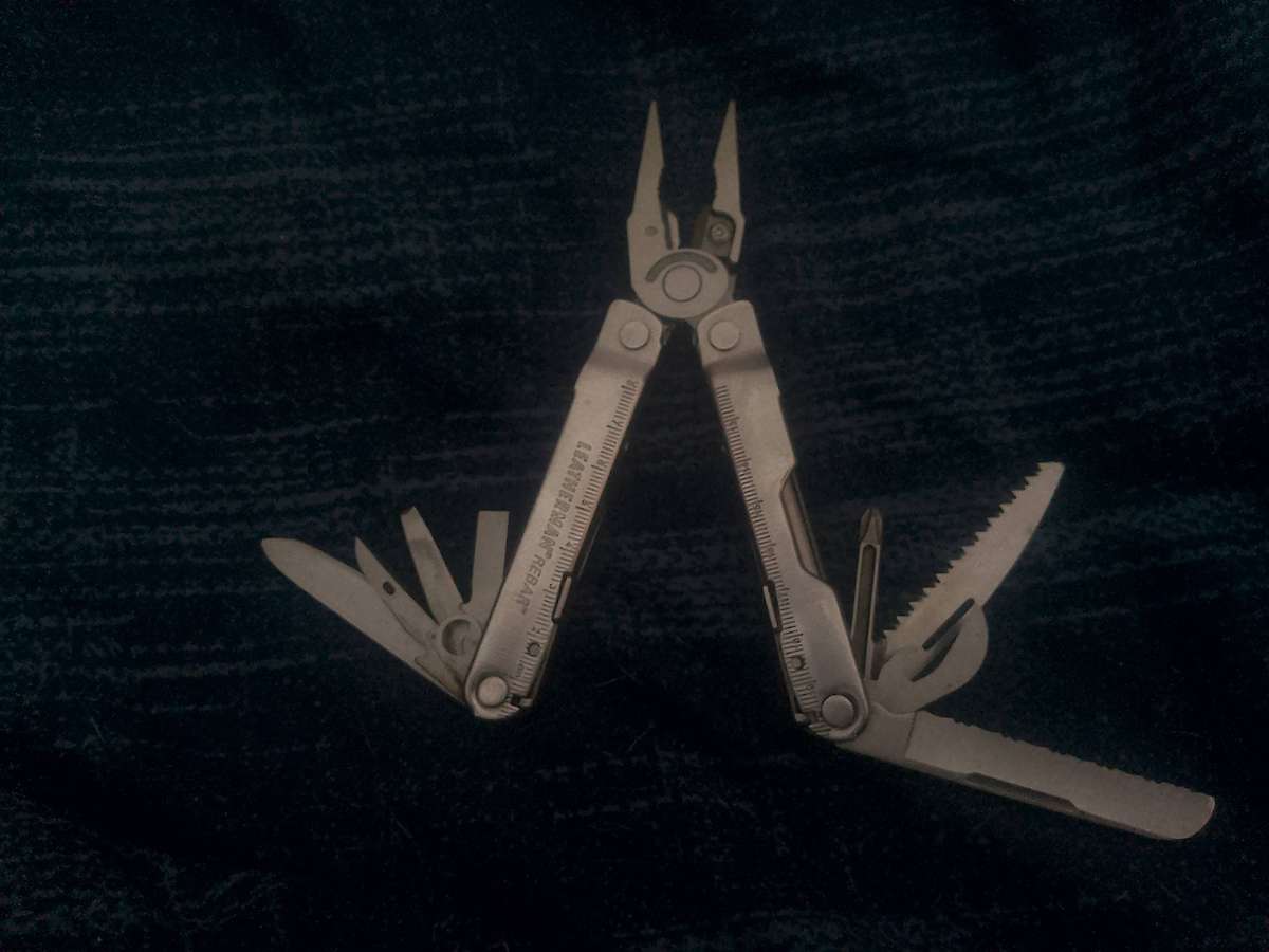 LEATHERMAN REBAR AND GENUINE LEATHER POUCH IN GOOD WORKING CONDITION.