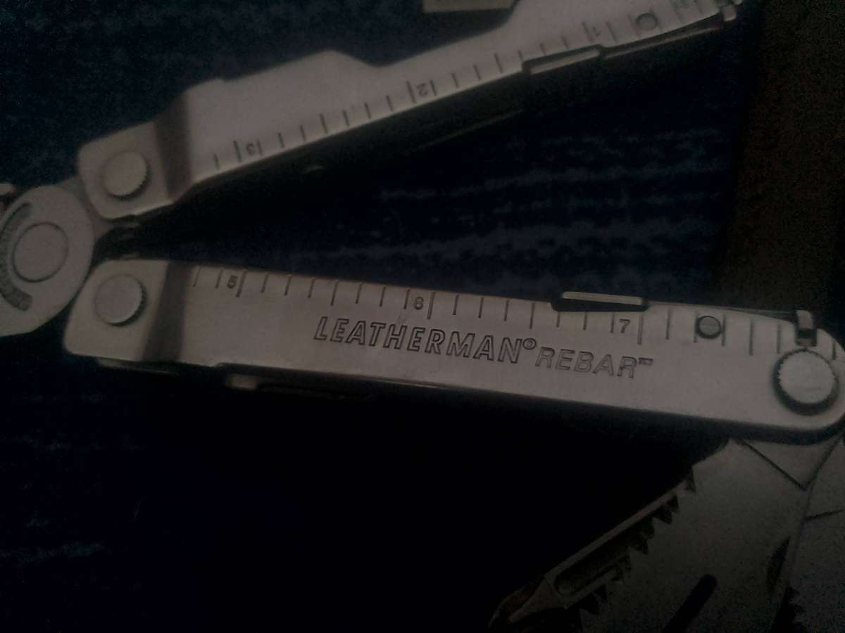 LEATHERMAN REBAR AND GENUINE LEATHER POUCH IN GOOD WORKING CONDITION.