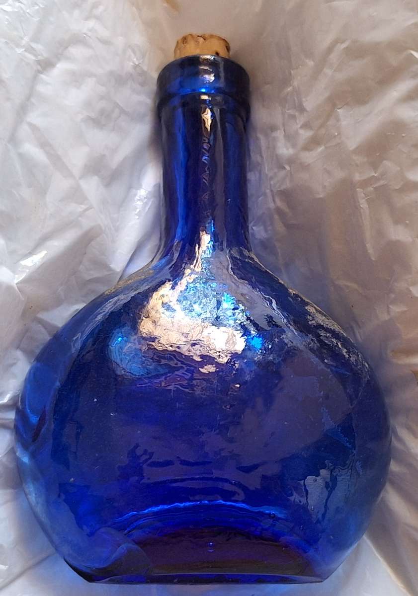 Small Blue Glass Bottle with Cork Stopper and Chip on Base