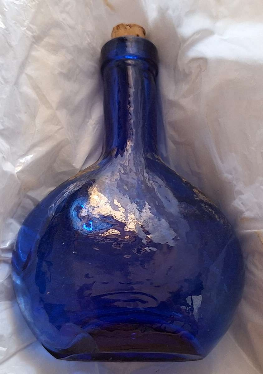 Small Blue Glass Bottle with Cork Stopper and Chip on Base