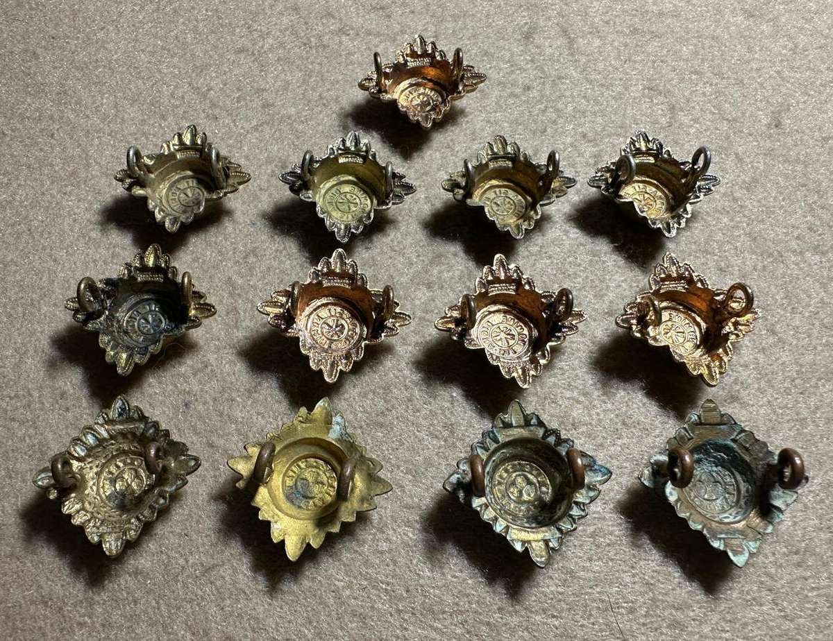 RHODESIA CROWNS AND PIPS - 13 BRASS PIPS WITH RED ENAMEL - VARIED