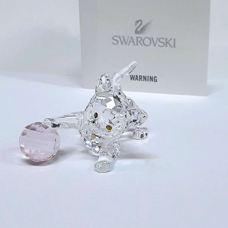 Swarovski Crystal Kitten is playing with a pink ball of wool