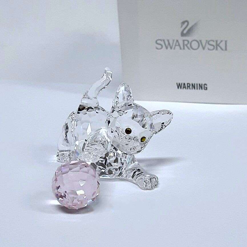 Swarovski Crystal Kitten is playing with a pink ball of wool