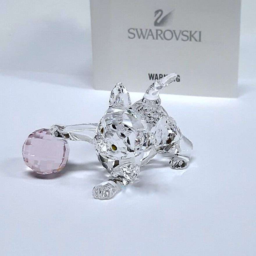 Swarovski Crystal Kitten is playing with a pink ball of wool