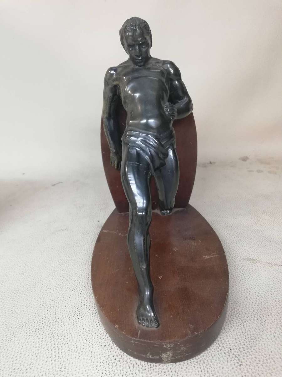 Vintage Bookend after R. Varmant, depicting a spelter leaning male athlete on a mahogany stand
