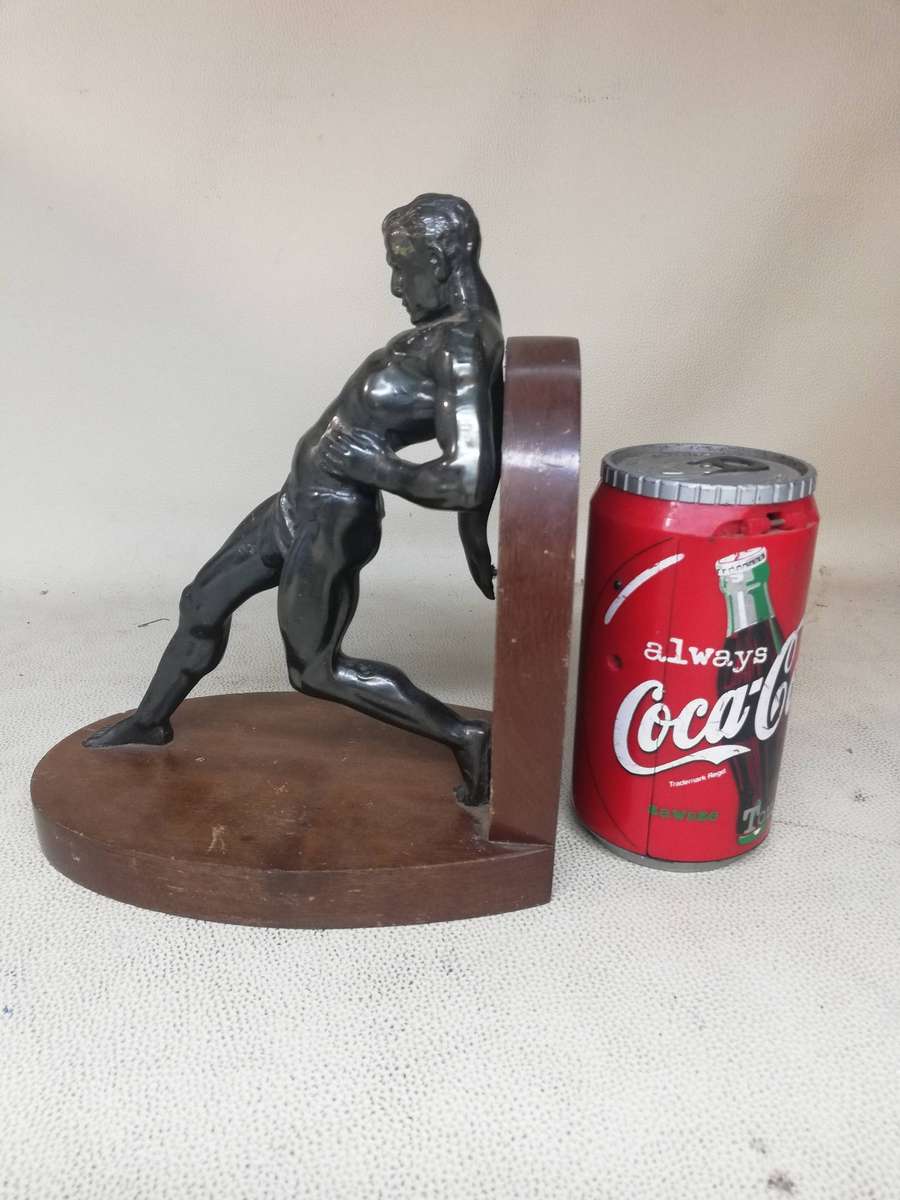 Vintage Bookend after R. Varmant, depicting a spelter leaning male athlete on a mahogany stand