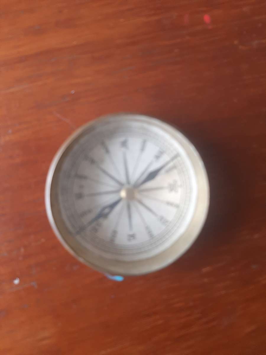 small compass in brass holder