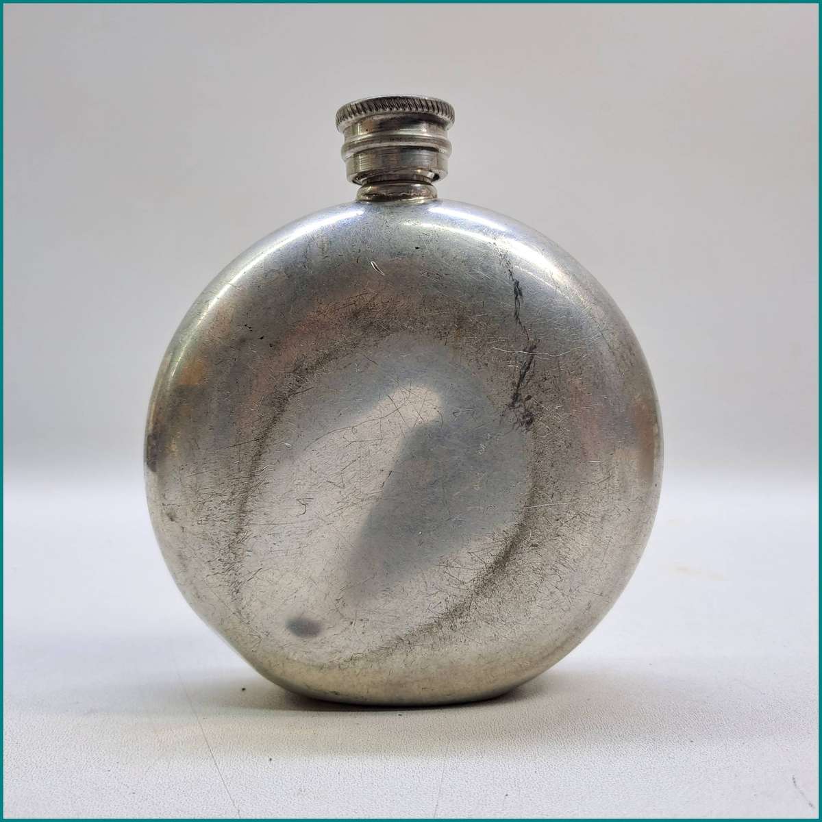Vintage English pewter round hip flask featuring a nautical porthole viewing window