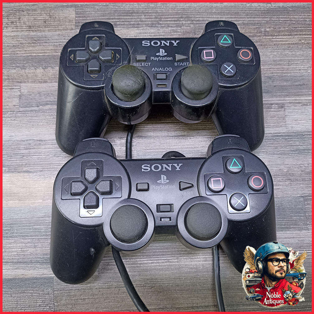 Two Sony PlayStation 2 DualShock 2 controllers