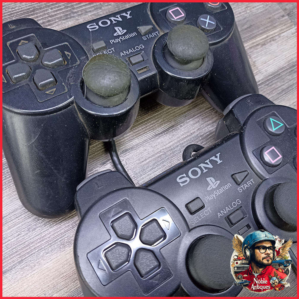 Two Sony PlayStation 2 DualShock 2 controllers